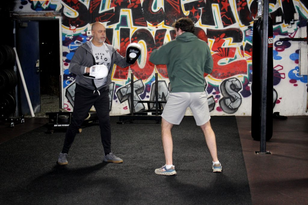 Kombat Fitness Coach Elis With Glove Work